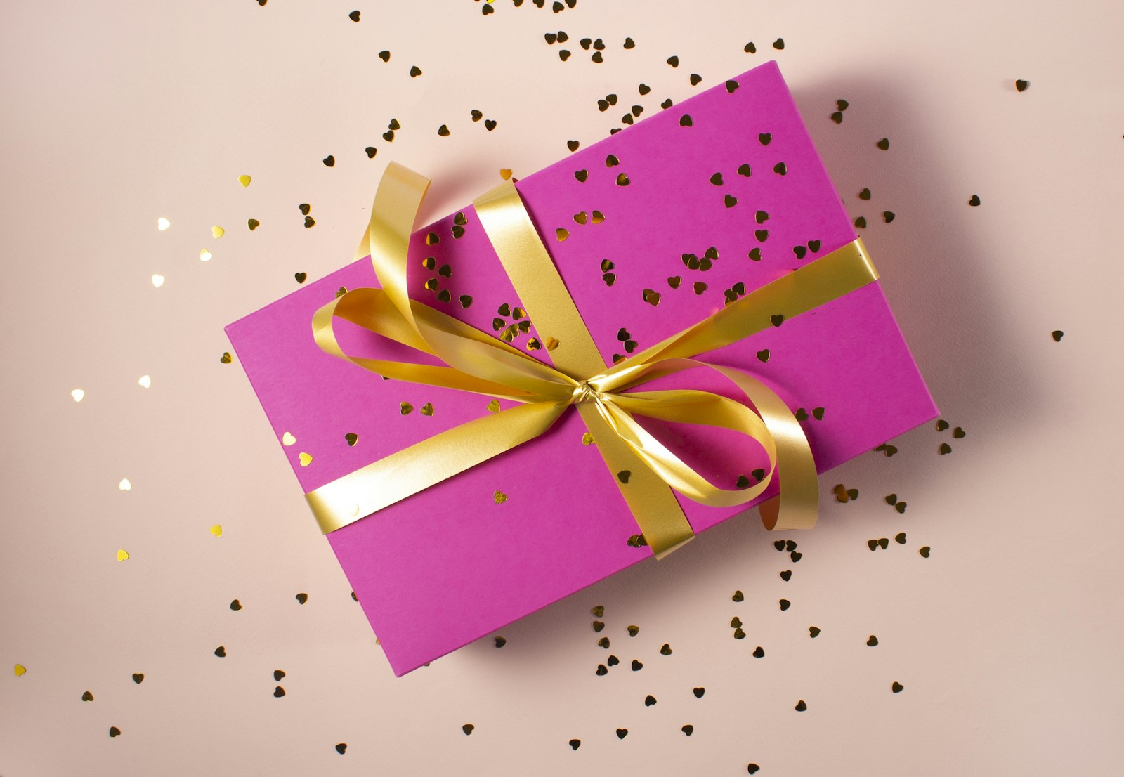 Pink gift box with golden ribbon